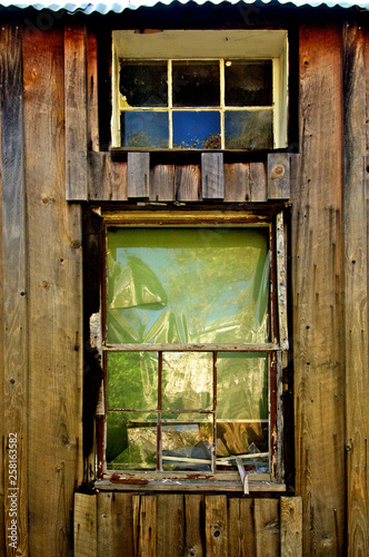 Old Broken Window with plastic sheet fix an example of the idiom “make due with what you have”