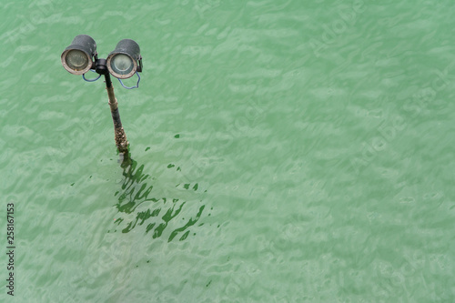 headlights above the water surface look like the eyes of a submerged robot © passsy
