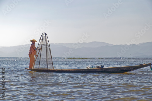Burma, Asia -  Fisherman in a wooden boat. © MiroslawKopec
