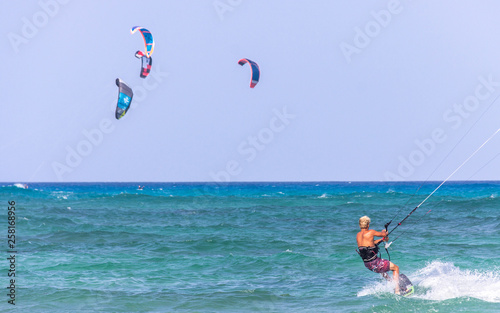 view of kitesurfer in the sea practicing sport a windy day