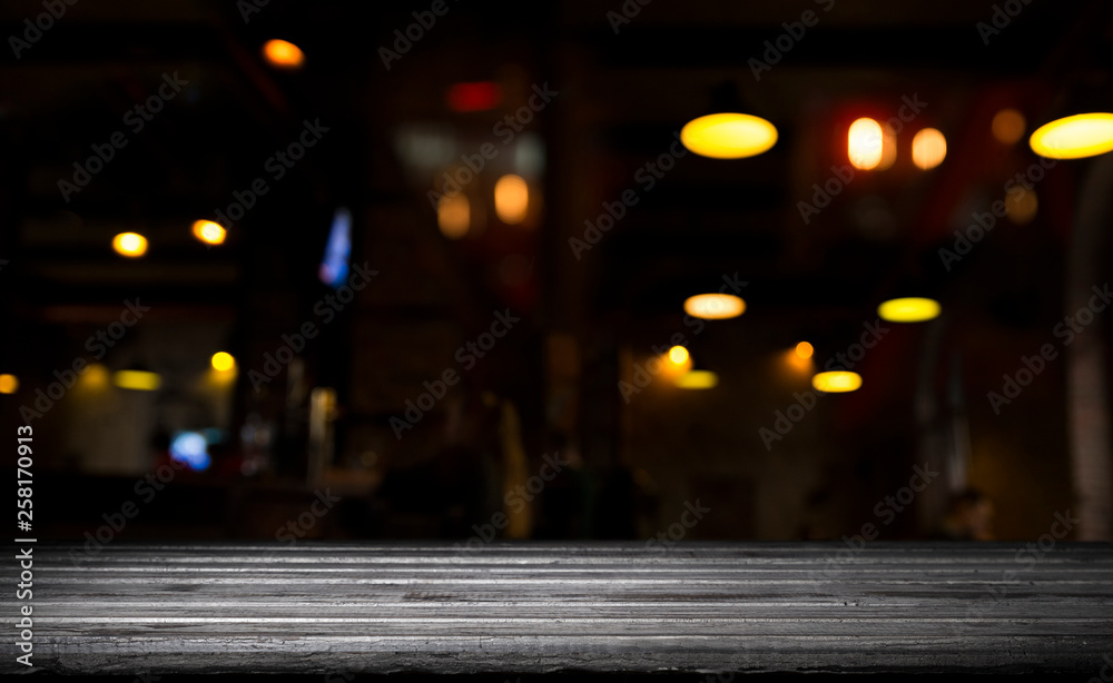 blurred background of bar and dark brown desk space of retro wood