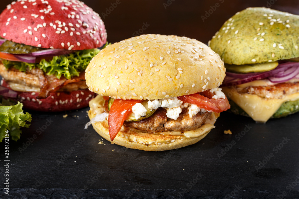 multicolored burgers close up multicolored burgers close up