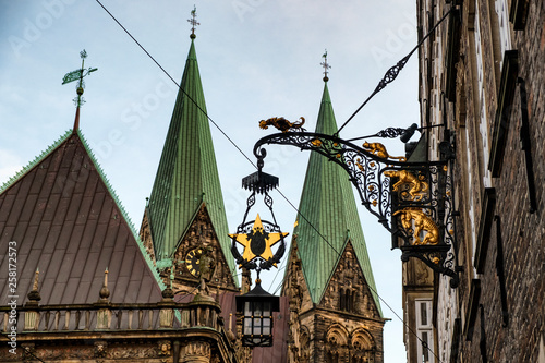 Spiers of the Cathedral of St. Peter  and sign with figures  Bremen Town Musicians  in  Bremen, Germany. March 2019 photo