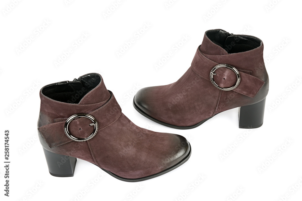 Elegant outfit. CloseUp of stylish suede ankle boots isolated on white background. Elegant outfit. CloseUp of stylish suede ankle boots isolated on white background.