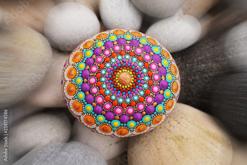 Beautiful mandala hand painted on a sea stone
