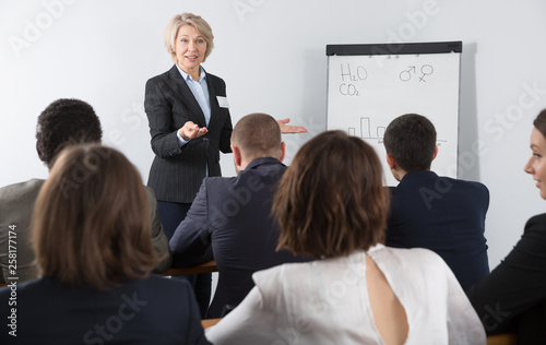 Senior woman giving speech in meeting room