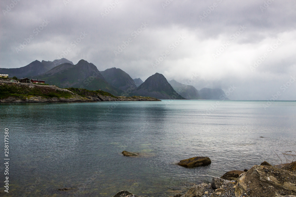 clouds over a fjord in the mountains on Senja island in Norway