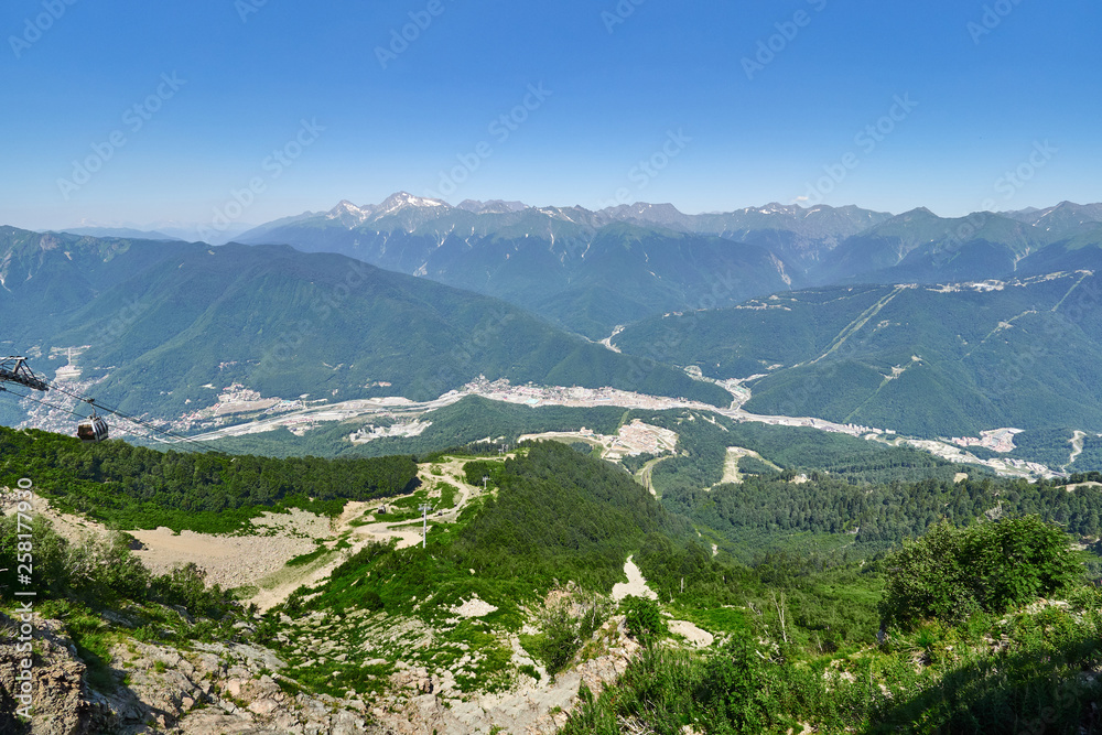 Fototapeta premium View over the Green Valley residential houses, surrounded by high mountains