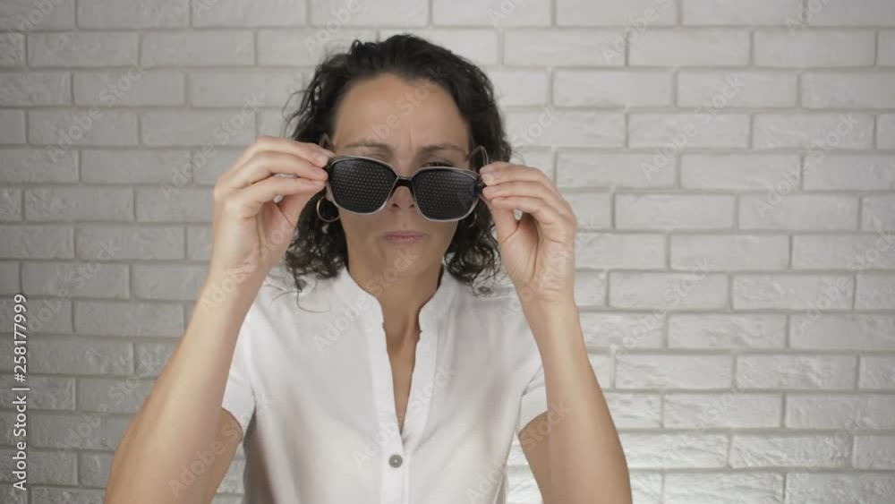 Woman in training glasses shows a victoria sign. Happy woman in obscura glasses. Woman in training glasses shows a victoria sign. Happy woman in obscura glasses.