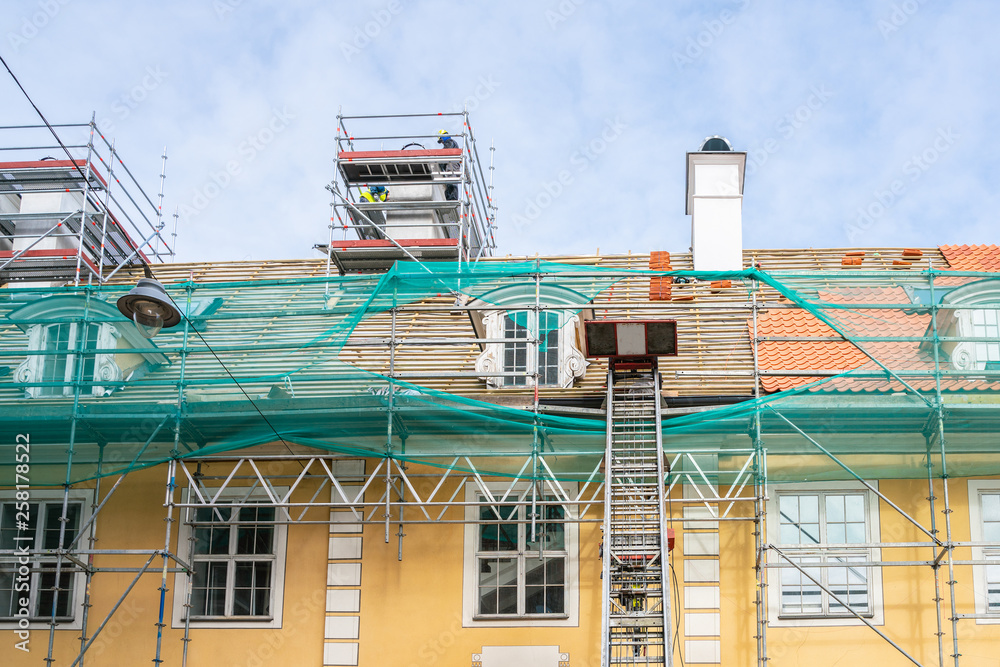 The process of repairing the roof, facade, chimneys. Laying tiles. Lift. The process of repairing the roof, facade, chimneys. Laying tiles. Lift.