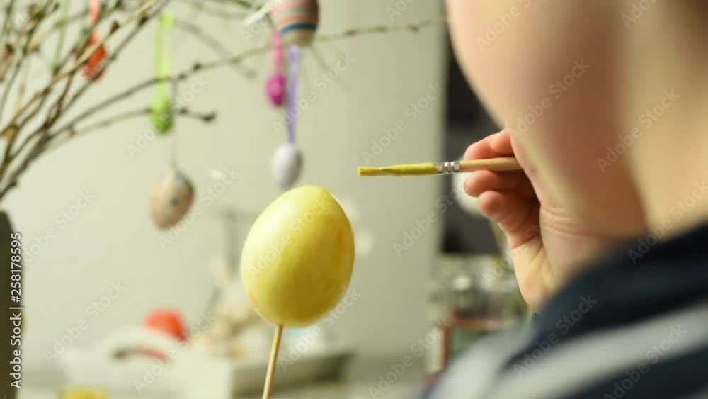 Young child painting easter eggs Young child painting easter eggs