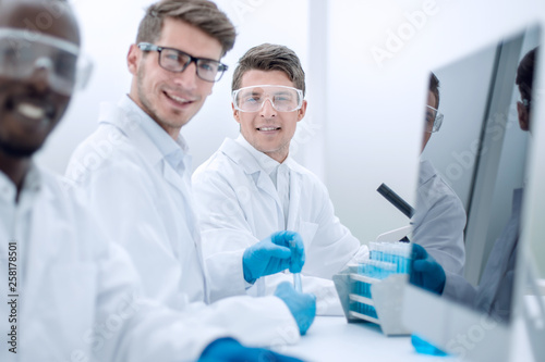 successful group of scientists sitting at their Desk