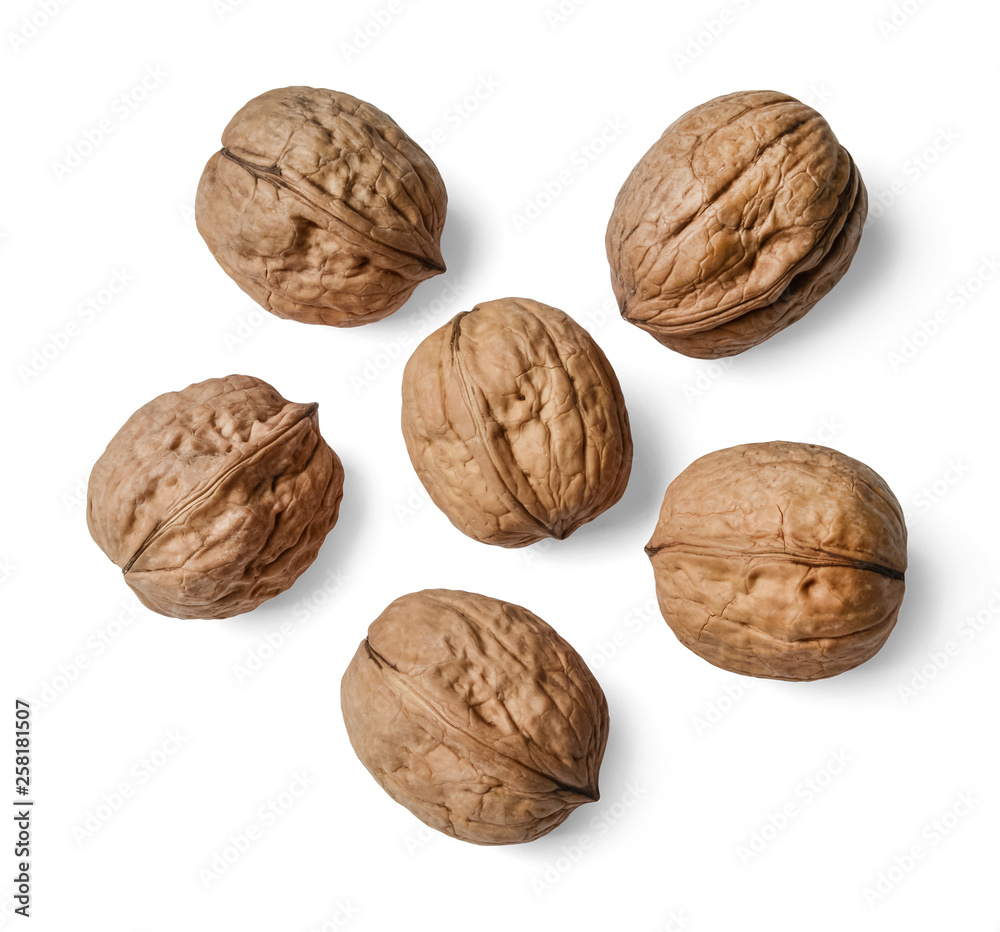 Whole walnuts on a white isolated background. View from above. Whole walnuts on a white isolated background. View from above.