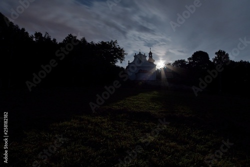 Church in the mountain village of Kvetnov in the Czech Republic under the moonlight. photo