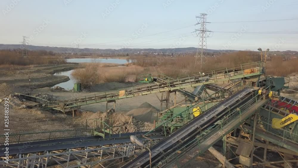 Elements of equipment for the extraction and sorting of rubble. Production of construction materials. Metal construction for working with stone and rocks. Slag of gravel under the conveyor belt Elements of equipment for the extraction and sorting of rubble. Production of construction materials. Metal construction for working with stone and rocks. Slag of gravel under the conveyor belt