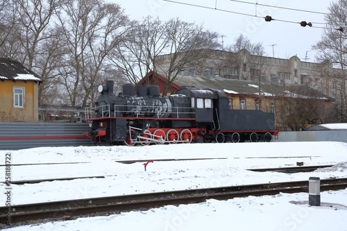 Beautiful old fashioned locomotive at the railway station in winter
