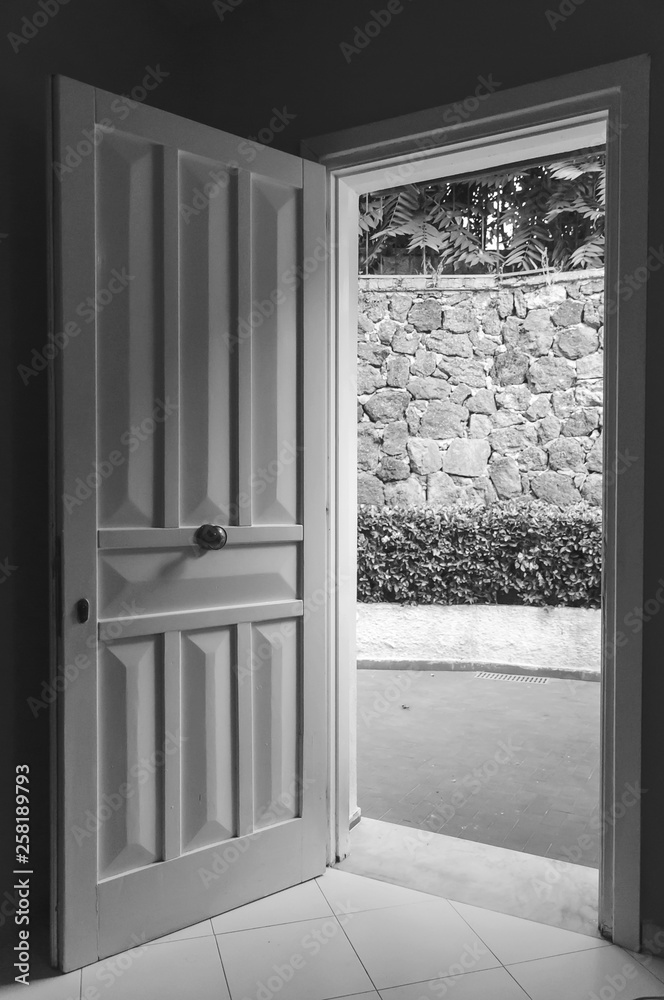 Fototapeta premium close up of an open door with a play of light and shadows
