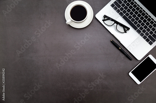 Workspace in office ,Black desk with blank notebook and other office supplies,Top view with copy space.