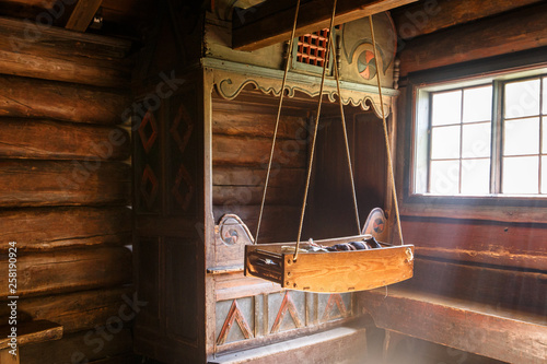 Antique Norwegian baby cradle with a doll