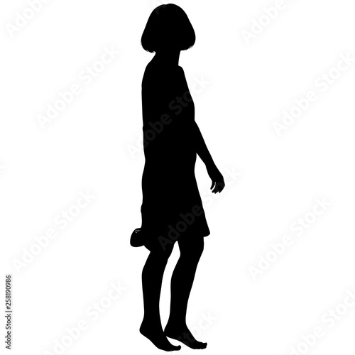 girl in short dress barefoot with shoes in her hand