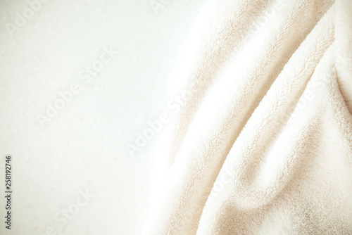 White delicate soft  background of plush fabric on white table. Copy space.