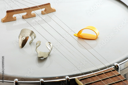 Closeup of 5-string Banjo and Finger Picks photo