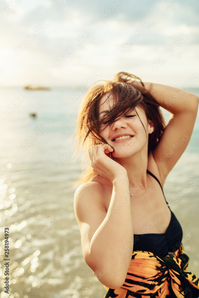 beautiful young girl in pareo walking on the sunset beach on sunlight in Philippines - Summer vacation background beautiful young girl in pareo walking on the sunset beach on sunlight in Philippines - Summer vacation background