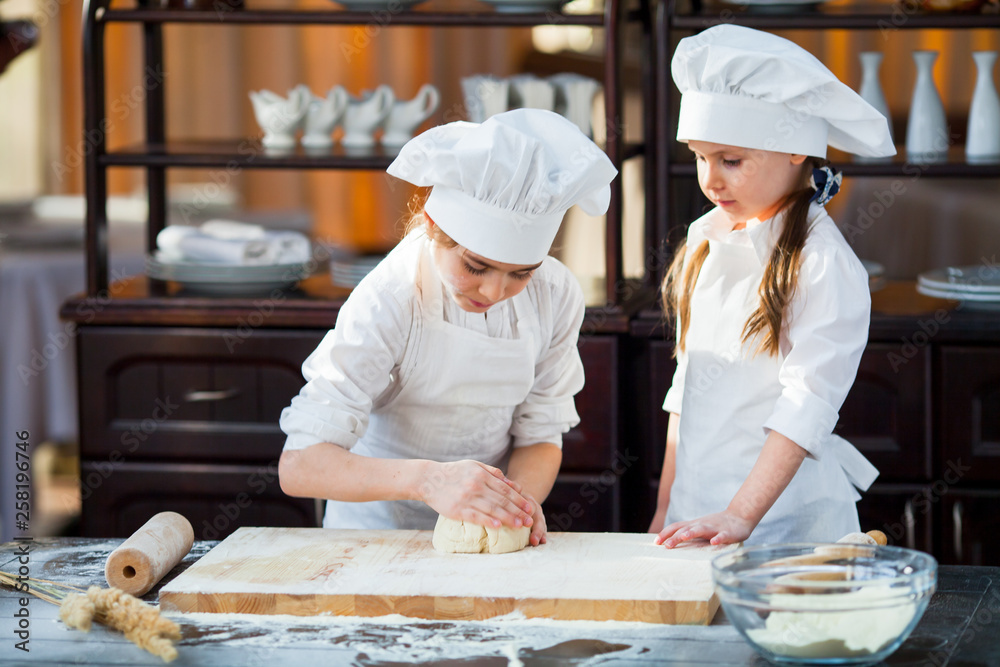 two girls make flour dough. two girls make flour dough.