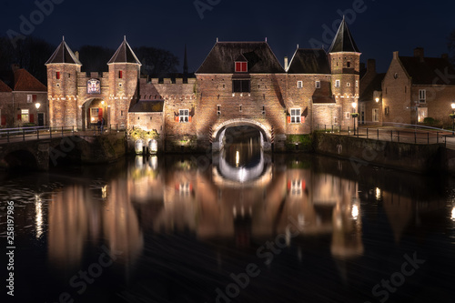 Medieval city gate as entrance over a flowing river; eem, in Amersfoort holland