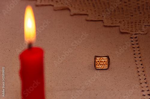 silver ring and burning candle photo