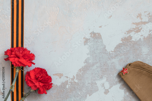 St. George ribbon and red carnation, may 9 Victory Day concept, symbol of the Second World war. photo