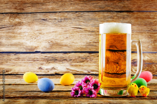 Photography Glass of cold light beer with Easter decorations on a wood background for the Ea