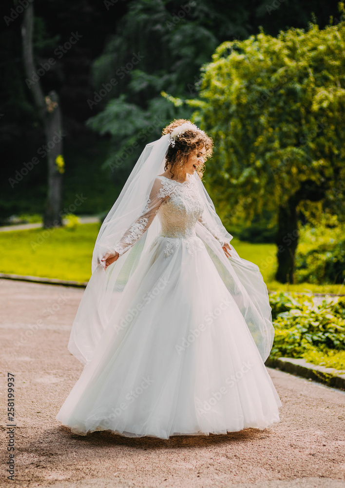Sweet bride in a white dress .whirl in the park Sweet bride in a white dress .whirl in the park
