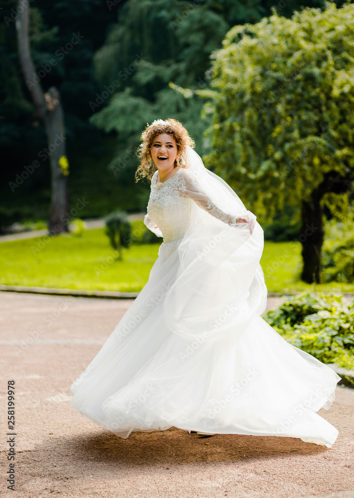Amazing bride in a white dress .whirl in the park Amazing bride in a white dress .whirl in the park