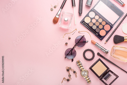Beauty concept in a blog. Professional female make-up accessories, watch, bracelet, lipstick, powder, on a pink background. Women's background and fashion. Instagram, women's things. Flat lay