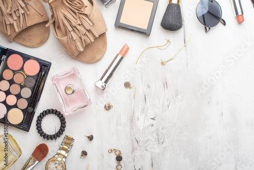 Beauty concept in a blog. Professional female make-up accessories, watch, bracelet, lipstick, brush, powder, on a marble background. Flat layout, top view, fashionable, feminine background. Flat lay