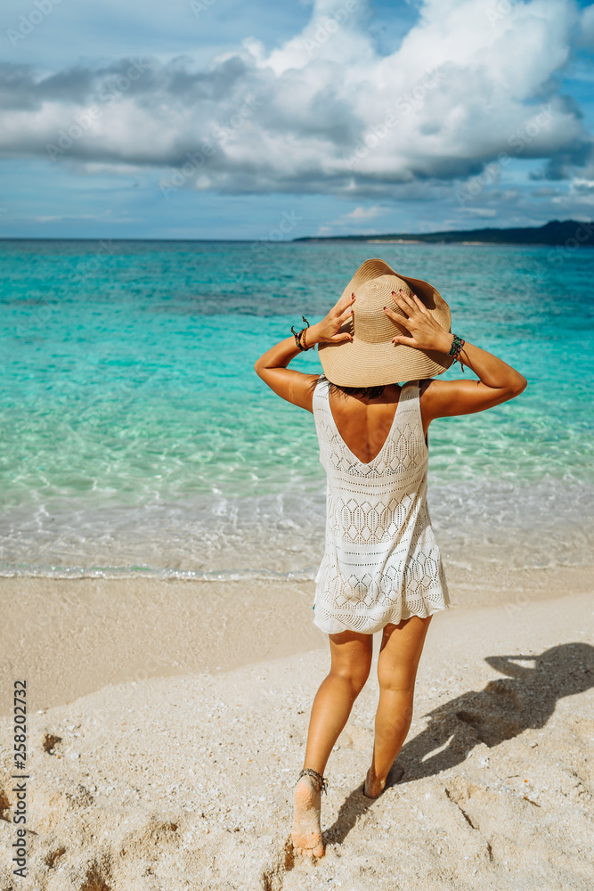 Girl on a tropical beach with hat. Philippines, Boracay Girl on a tropical beach with hat. Philippines, Boracay