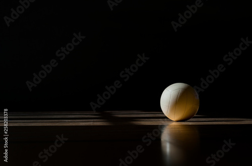 Принти на полотні Volleyball court wooden floor with ball isolated on black with copy-space