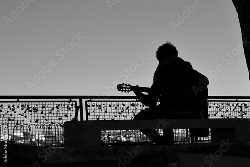 Musician playing the guitar on a viewpoint in Lisbon photo