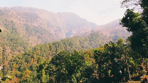 Moving forward to forest and mountain valley in summer day. Asia, Nepal. Outdoor green nature scape mountains.