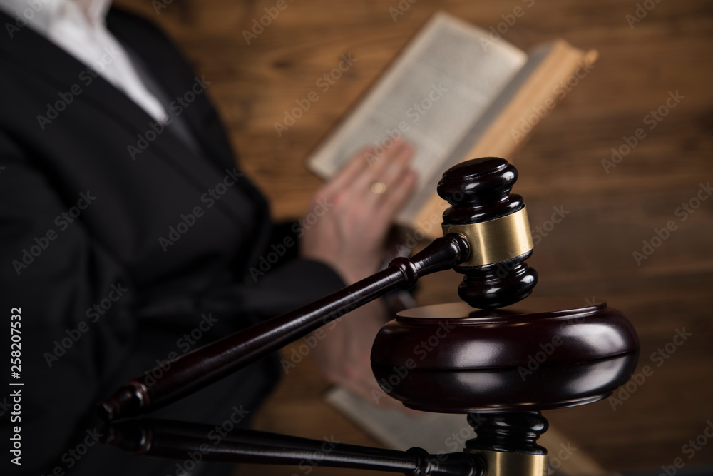 Judge, male judge in a courtroom striking the gavel Judge, male judge in a courtroom striking the gavel