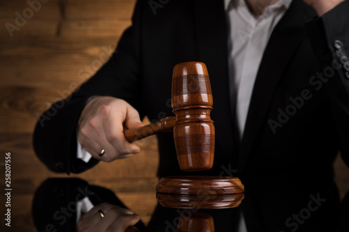 Judge, male judge in a courtroom striking the gavel