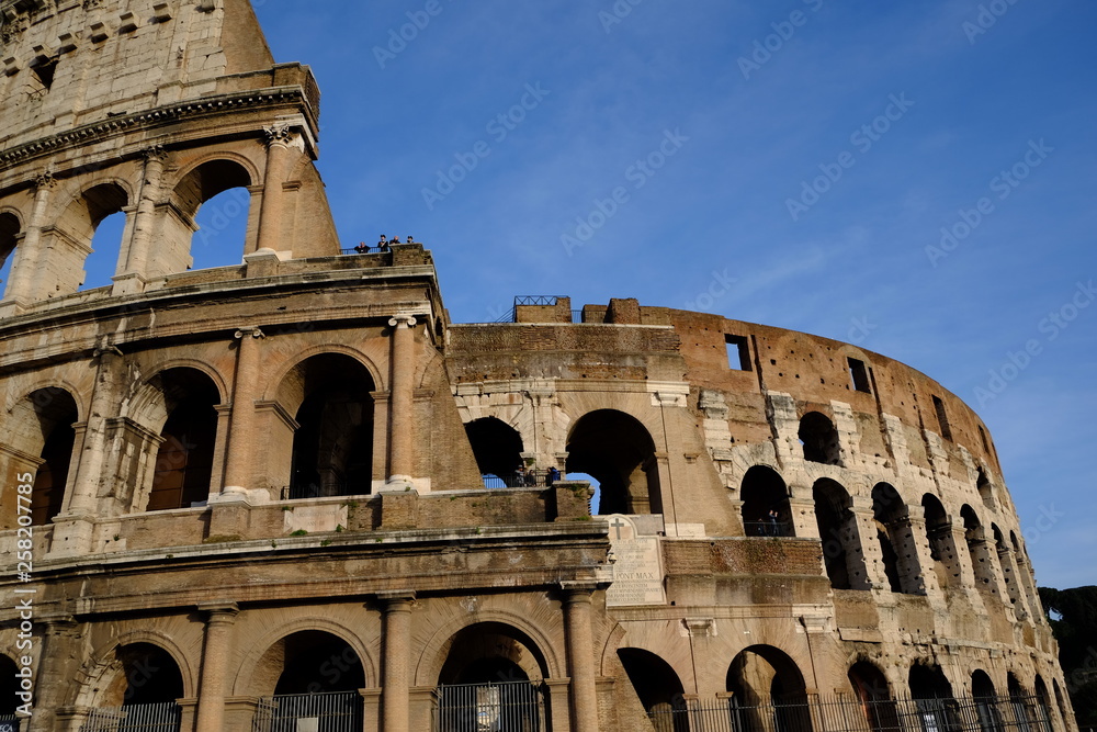 ancient colosseum in rome on blue sky background 