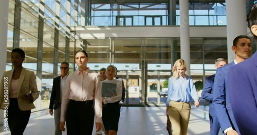 Multi ethnic business people walking together in the lobby at office 4k photo