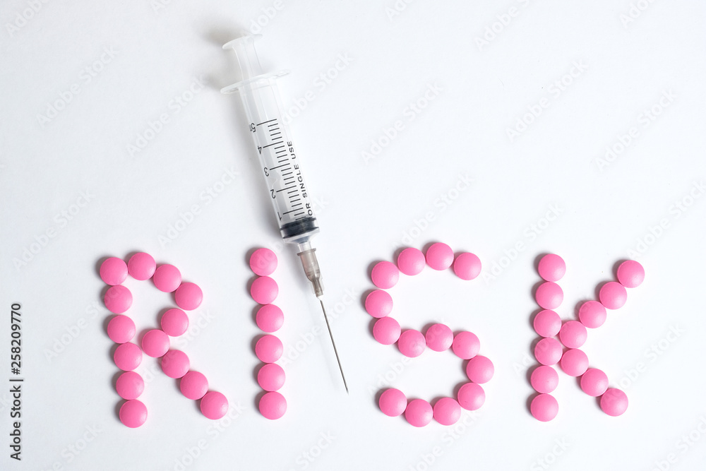 Risk concept using syringe and vaccinations. Chance to catch and get sick. Syringe and the word Risk concept using syringe and vaccinations. Chance to catch and get sick. Syringe and the word