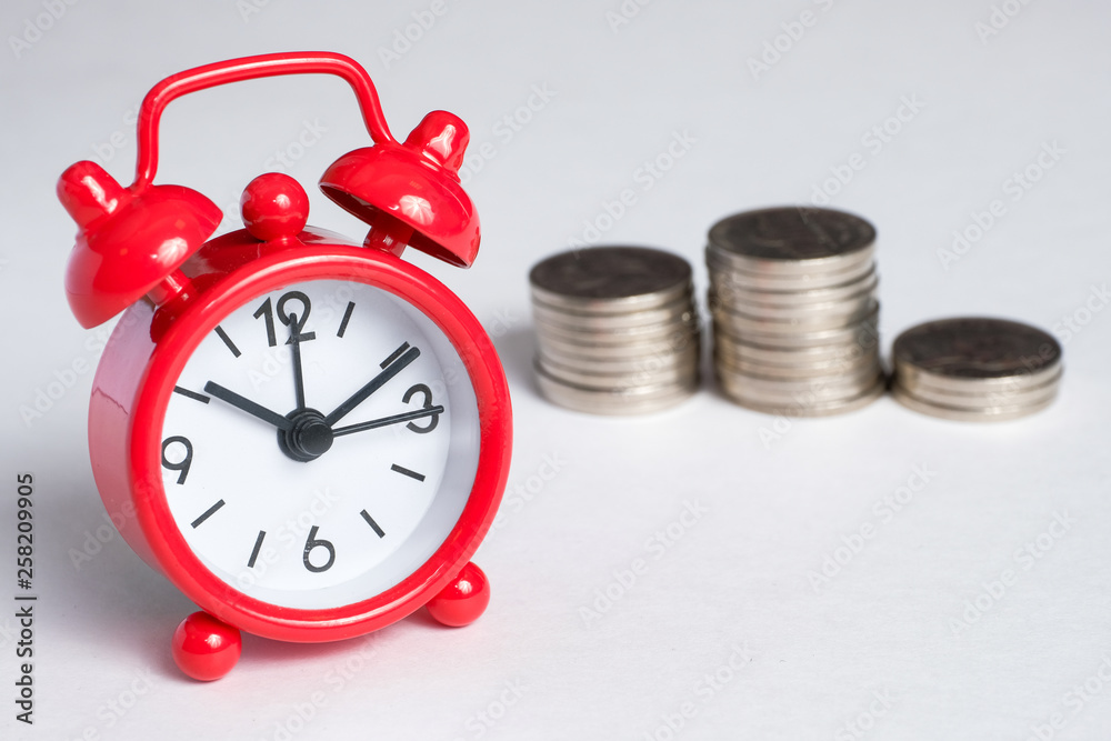Concept of saving time and money in business. Efficiency increase. Classic clock on the background of the hills of coins.