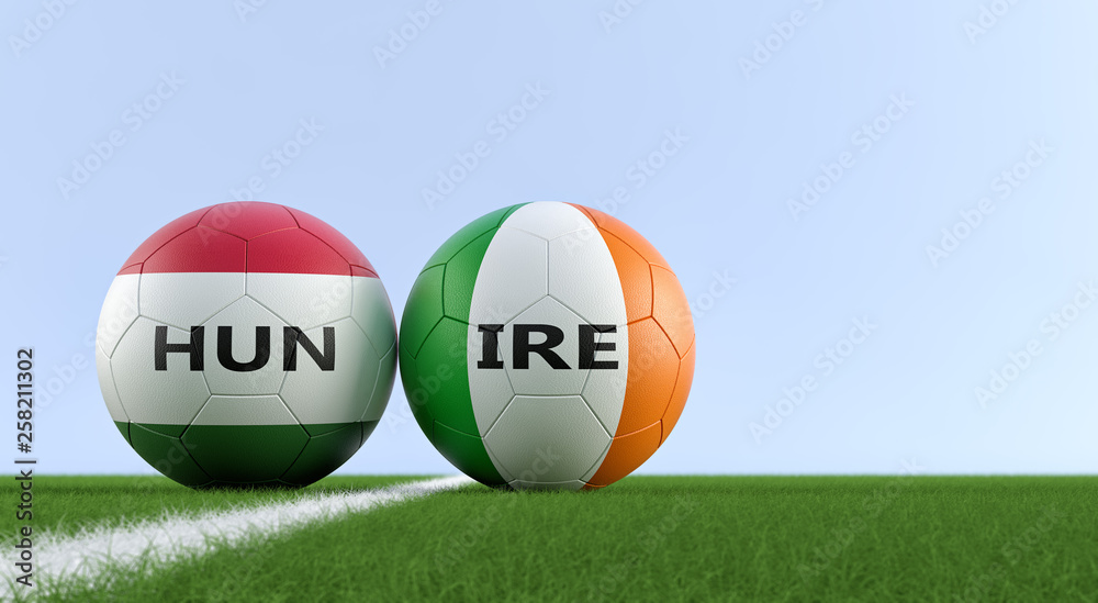 Hungary vs. Ireland Soccer Match - Soccer balls in Hungarys and Irelands national colors on a soccer field. Copy space on the right side - 3D Rendering Hungary vs. Ireland Soccer Match - Soccer balls in Hungarys and Irelands national colors on a soccer field. Copy space on the right side - 3D Rendering
