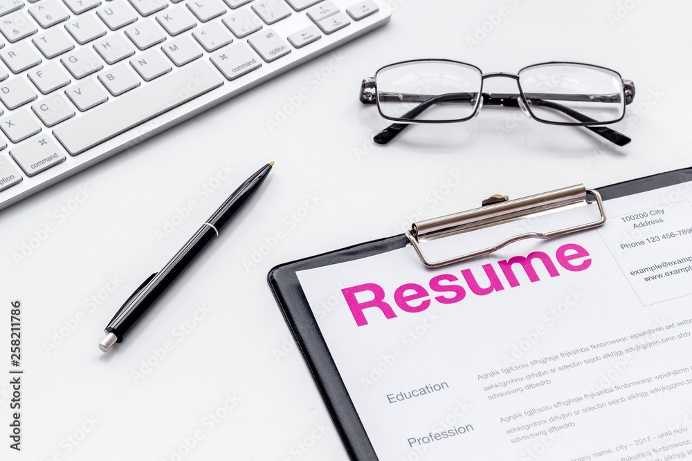 Review resumes of applicants set with keyboard and glasses white work desk background Review resumes of applicants set with keyboard and glasses white work desk background