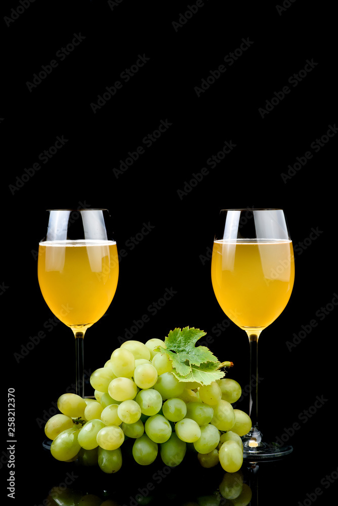 Glass of wine and grape on black background Glass of wine and grape on black background