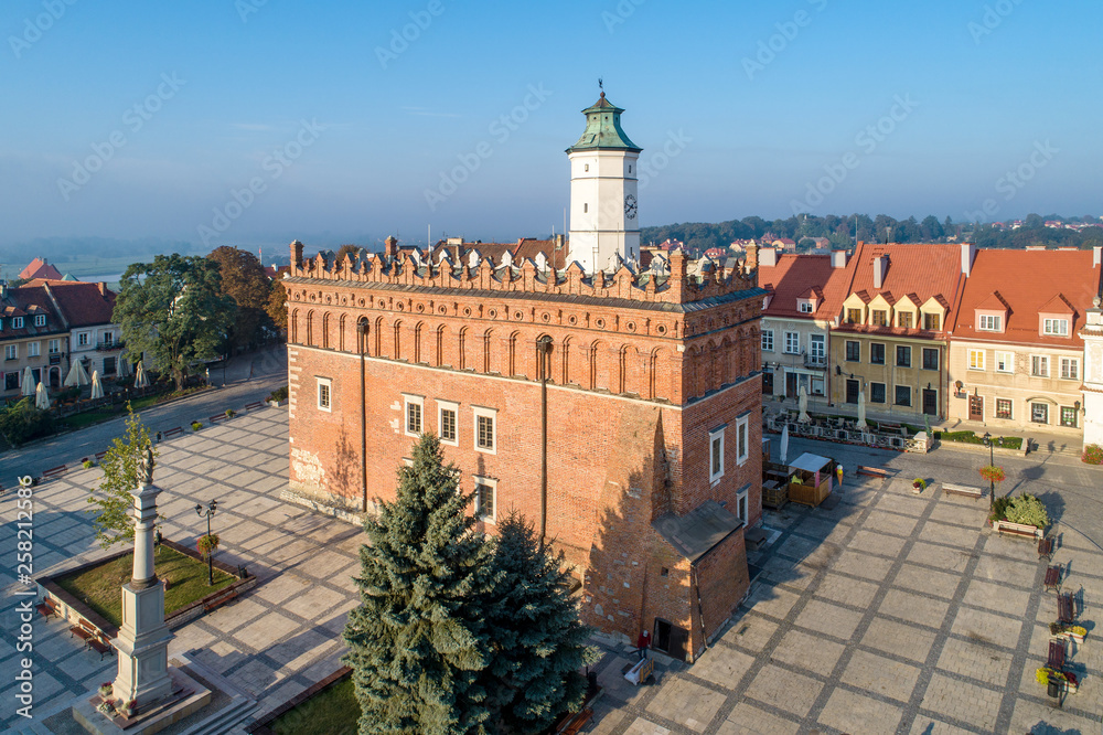 Sandomierz old city, Poland. Aerial view in sunrise light. Gothic city hall with clock tower and Renaissance attic and St Mary statue in the market Square (Rynek). One of the oldest towns in Poland.